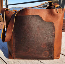 Load image into Gallery viewer, handmade brown leather bag using the raw edge of hide for a one of a kind piece.